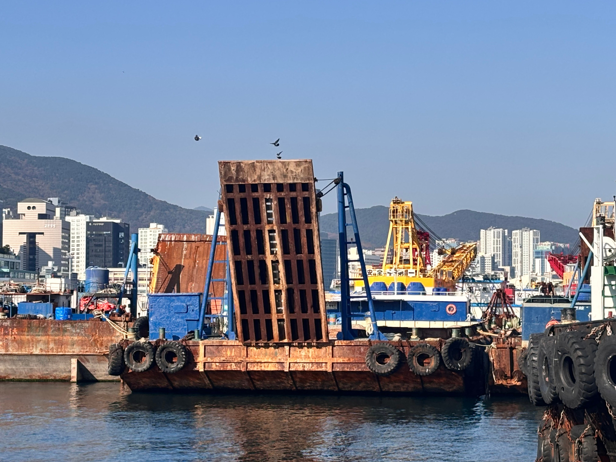Front view of a ramp-equipped barge at a harbor